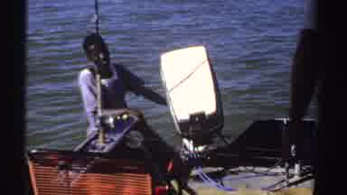 Sudan (1969): A Man Cuts Into His Catch While His Assistant Watches