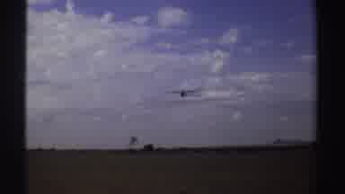 Sudan (1969): View Of Airplane Flying In Blue Sky Under Grey Clouds