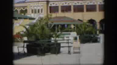 Utah (1951): A Few Outdoor Tables With Sun Umbrellas In Front Of A Building