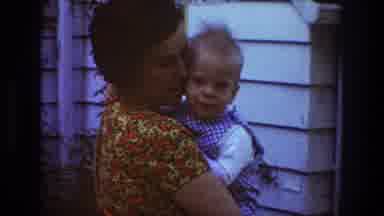 Toledo Ohio (1968): Woman Wearing Red And Yellow Dress Holds Small Boy Wearing