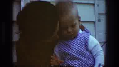 Toledo Ohio (1968): A Woman Holding Her Baby And Cuddling Him On Her Laps