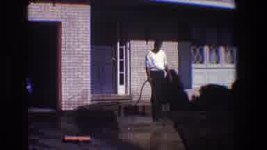 Toledo Ohio (1968): Guy Using Garden Hose To Wash Off Front Walkway Up To House On