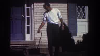 Toledo Ohio (1968): Man Wearing White Shirt Sprays Ground With Small Wand On A