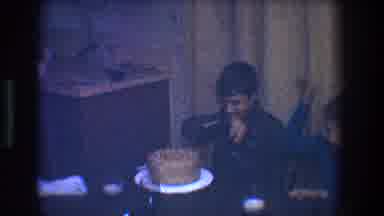 Toledo Ohio (1968): Boy Wearing Brown Shirt Waves Arms Over Brown Cake Before