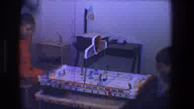 Toledo Ohio (1968): Two Boys Play With Tabletop Rocky Game Board On Tan Table
