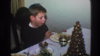 Toledo Ohio (1968): At Christmastime A Boy Eating Dinner Gives An Exaggerated Grin