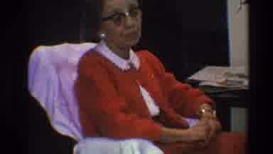 Toledo Ohio (1968): Elderly Woman In Red Sweater And Eyeglasses Sits In Chair And