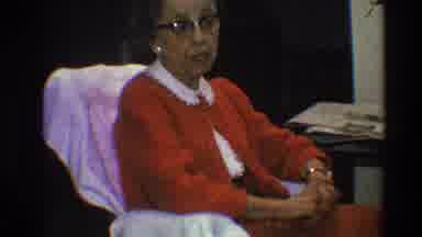 Toledo Ohio (1968): An Old Lady Wearing An All Red Attire Sitting In A Chair And A