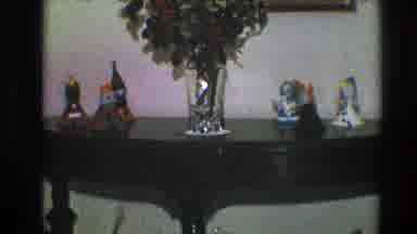 Toledo Ohio (1968): A Black Wood Console Table That Has A Vase With Plants And