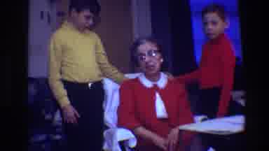 Toledo Ohio (1968): An Older Woman Sitting In A Chair With Two Children On Either