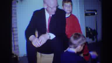 Toledo Ohio (1968): Boy In Red Pajamas Sitting Behind Father On Couch Laughs At