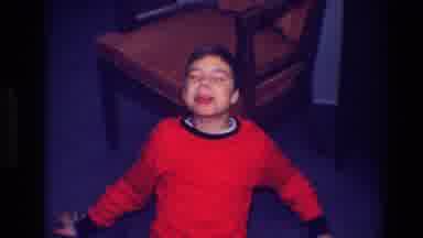 Toledo Ohio (1968): Boy Wearing Red And Black Pajamas Makes Funny Faces At Camera