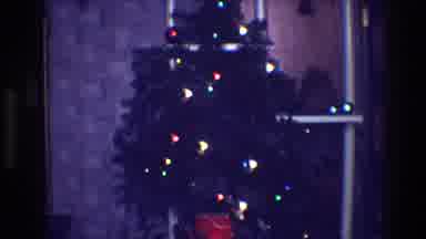 Toledo Ohio (1968): A Green Christmas Tree Full Of Colored Lights Decorating A