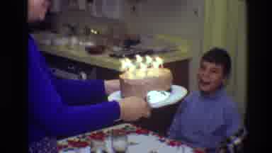Toledo Ohio (1968): A Woman Carries A Birthday Cake With Lit Candles Over To A