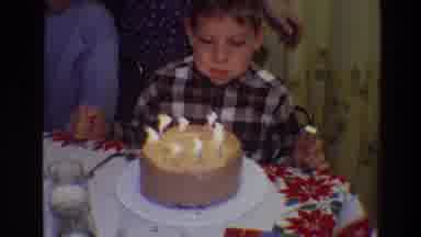 Toledo Ohio (1968): Boy Wearing Blue Plaid Shirt Blows Out Candles On Brown Cake