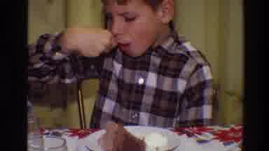 Toledo Ohio (1968): Boy Wearing Brown Plaid Shirt Sits At Red And White Table
