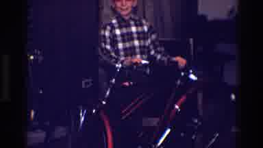 Toledo Ohio (1968): A Kid Wearing A Plaid Shirt And Trying To Rise Up On A Red