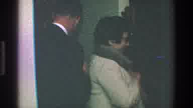 Toledo Ohio (1968): A Woman Putting On A Coat At The Door With A Fur Hood