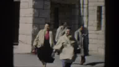 Texas (1951): Women Wearing Grey Sweaters Leave White Stone Building On A Sunny