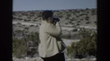 Texas (1951): Cars Passing On Dirt Road People Walking And Woman Filming View Of