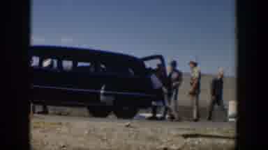 Texas (1951): Men Gather Near Large Mid century Vehicle While One Man Struggles To
