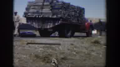 Texas (1951): View Of Red Truck Loaded With Wooden Items On A Clear Day