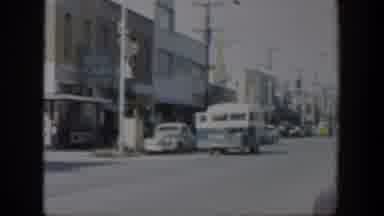 Texas (1951): A Busy City Street With A Bus And Cars Driving By