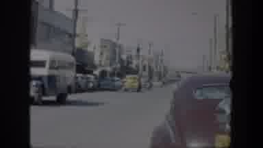 Texas (1951): A View Of A Busy Street With Cars Driving Slowly Towards The