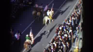 Texas (1951): A Parade With People On Horses Holding Flags And People Watch