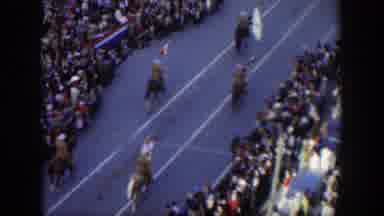 Texas (1951): A Horseback Parade Going Down A Street Lines With Crowds Of People
