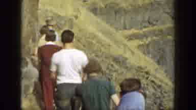 California (1937): Group Of People Hiking On Rocky Trail On A Clear Day