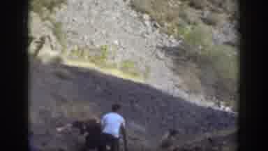 California (1937): A Man Helps A Woman Climb Up And Other People Watch