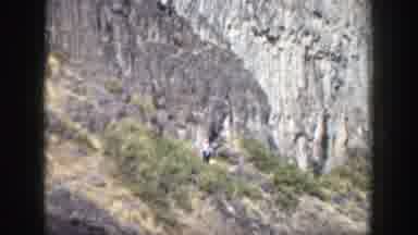 California (1937): Person Wearing White Shirt Walks Down Grey Rocky Trail On A