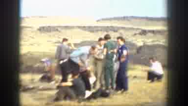 California (1937): Group Of People Standing And Talking In Tan Field On A Sunny