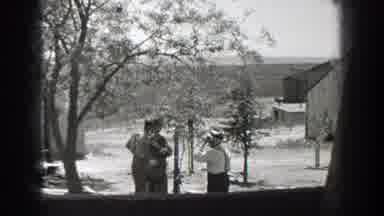 California (1937): Man Wearing White Shirt Talks To Soldiers On A Clear Sunny Day