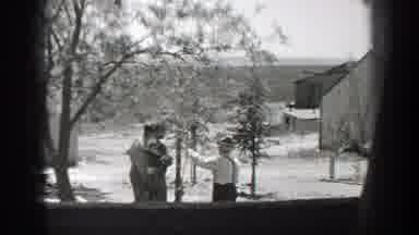 California (1937): Man Sitting Workers Meeting Woman Entering House