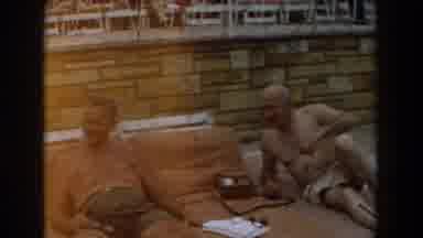Los Angeles California-1961: Two Men Relax On Tan Towels By Poolside