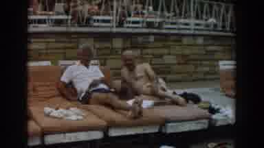 Los Angeles California (1961): View Of Two Men Resting On Tan Towels While People