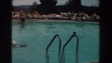 Los Angeles California (1961): Three People Relax In Pool While Three Men Relax On