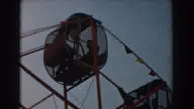 Los Angeles California (1961): People Riding Red Metal Ferris Wheel On A Clear Day