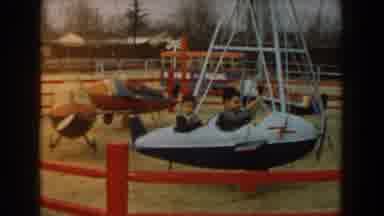 Los Angeles California (1961): Two Children Play In A Two Seater Airplane Carousel