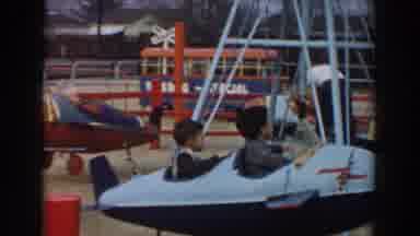 Los Angeles California (1961): Two Kids Sit In Blue Airplane Amusement Ride On A