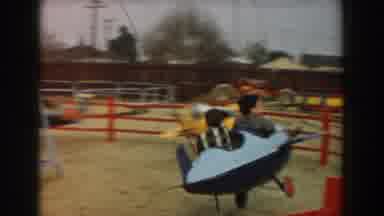 Los Angeles California (1961): Children Having Fun On Toy In Amusement Park