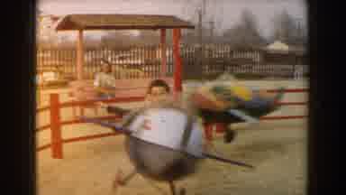 Los Angeles California (1961): Kids Riding In Airplane Shaped Cars On Kiddie Ride