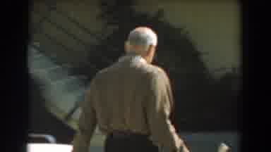 Los Angeles California (1961): A Man With A Brown Shirt And Glasses Walking Toward