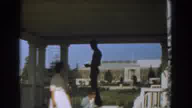 Los Angeles California (1961): Woman Wearing White Dress Stands With Boy Wearing