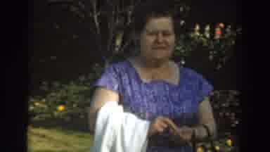 Los Angeles California (1961): Woman Wearing Blue Dress Smiles At Camera While