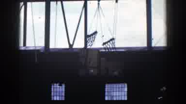New York (1948): A Crane Lifting Large Boxes Off Of The Floor That Are Wrapping In