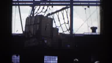 New York (1948): View Of Brown Crates Lowered By Cargo Net Into Boat On A Clear