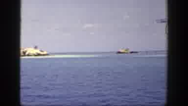 New York (1948): Passing View Of Blue Ocean Water And Tan Object On A Clear Day